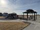 View of the community park, featuring a gazebo, picnic tables, benches, and a playground at 48290 Shetland Dr, Bennett, CO 80102