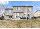 Exterior back of home with a gray siding and a small patio area leading to the large backyard at 11204 Eaton Way, Westminster, CO 80020