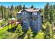 Charming home features a spacious outdoor deck perfect for entertaining or relaxing at 30889 Manitoba Dr, Evergreen, CO 80439