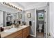 Well-lit bathroom with double sinks, a large mirror, and a neutral color scheme, offering a clean and functional space at 30889 Manitoba Dr, Evergreen, CO 80439