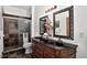Elegant bathroom with a double vanity, stylish mirrors, and a tiled shower at 30889 Manitoba Dr, Evergreen, CO 80439