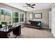 Bright bedroom with large windows, a futon, and a ceiling fan, creating a relaxing space for work or rest at 30889 Manitoba Dr, Evergreen, CO 80439