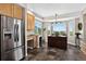 Bright breakfast nook features stainless steel refrigerator, rich wood cabinetry, and stunning mountain views at 30889 Manitoba Dr, Evergreen, CO 80439