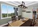 Bright dining area with stunning views, a rustic chandelier, and seamlessly connects to the kitchen at 30889 Manitoba Dr, Evergreen, CO 80439