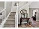 Inviting entryway with neutral tones, stylish decor, and a staircase leading to the upper level at 30889 Manitoba Dr, Evergreen, CO 80439