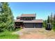 Well-maintained home with a three-car garage, wooden deck, and scenic views at 30889 Manitoba Dr, Evergreen, CO 80439