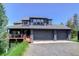 Attractive three-car garage home with ample windows and outdoor deck with mountain views at 30889 Manitoba Dr, Evergreen, CO 80439