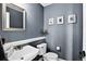 Tastefully designed half bath with a sleek vanity, modern toilet, and decorative wall art, showcasing style and functionality at 30889 Manitoba Dr, Evergreen, CO 80439