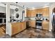 Well-equipped kitchen with stainless steel appliances, ample wood cabinetry, and tiled floors at 30889 Manitoba Dr, Evergreen, CO 80439