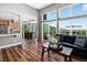 Open-concept living room with hardwood floors, large windows offering scenic views, and stylish furnishings at 30889 Manitoba Dr, Evergreen, CO 80439