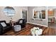 Comfortable living room with hardwood floors, neutral tones, and a glimpse into the adjacent kitchen at 30889 Manitoba Dr, Evergreen, CO 80439