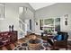 Inviting living room with soaring ceilings, abundant natural light, and hardwood floors at 30889 Manitoba Dr, Evergreen, CO 80439