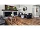Cozy living room featuring hardwood floors, a fireplace, comfortable seating, and stylish decor at 30889 Manitoba Dr, Evergreen, CO 80439