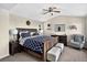 Cozy primary bedroom with a wooden bed frame, stylish bedding, and a ceiling fan, perfect for relaxation at 30889 Manitoba Dr, Evergreen, CO 80439