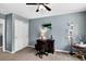 Functional home office with a wooden desk, comfortable chair, and ample natural light, creating an ideal workspace at 30889 Manitoba Dr, Evergreen, CO 80439