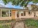 House entrance with brick pathway and landscaping at 9154 Flamingo Way, Littleton, CO 80125