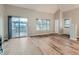 Living room with wood floors, sliding door to deck, and mountain views at 9154 Flamingo Way, Littleton, CO 80125