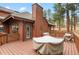 Outdoor wooden deck showcasing covered tables, perfect for entertaining guests at 29857 Park Village Dr, Evergreen, CO 80439
