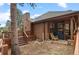 Cozy home exterior with a quaint porch, wooden deck, and scenic surroundings at 29857 Park Village Dr, Evergreen, CO 80439