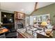 Comfortable living room with a stone fireplace and abundant natural light at 29857 Park Village Dr, Evergreen, CO 80439