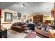 Comfortable living room with plush couches, area rug, and built-in shelving with accent lighting at 29857 Park Village Dr, Evergreen, CO 80439