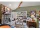 Comfortable living room with a stone fireplace and abundant natural light at 29857 Park Village Dr, Evergreen, CO 80439