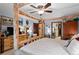 Primary bedroom with a ceiling fan, wood bed frame and bright natural light at 29857 Park Village Dr, Evergreen, CO 80439