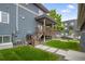 Well-maintained backyard with a cozy porch and stairs leading to the lawn at 4184 Kalamath St, Denver, CO 80211