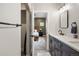 Modern bathroom with dark wood cabinets, white quartz countertops, and a bedroom view at 4184 Kalamath St, Denver, CO 80211