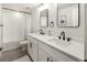 Bright bathroom featuring dual sinks, black fixtures, and modern vanity mirrors at 4184 Kalamath St, Denver, CO 80211