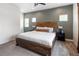 This primary bedroom features an accent wall, plush carpet, and a rustic wood bed frame at 4184 Kalamath St, Denver, CO 80211