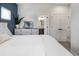 Bedroom boasting a dresser, plant, and doorway leading to a bathroom with modern finishes and fixtures at 4184 Kalamath St, Denver, CO 80211