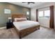 Bedroom with warm wood tones, highlighted by natural light from a large window and a modern ceiling fan at 4184 Kalamath St, Denver, CO 80211