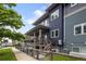 Beautiful home exterior featuring a covered porch, stairs, and green lawn at 4184 Kalamath St, Denver, CO 80211