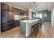 A modern kitchen with stainless steel appliances and a large island that provides seating for four at 4184 Kalamath St, Denver, CO 80211