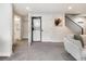Basement hallway with laundry closet, stairway, and bathroom doorway at 4184 Kalamath St, Denver, CO 80211