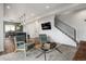 Open-concept living room showcasing modern decor, a comfortable seating area, and seamless flow into the dining space at 4184 Kalamath St, Denver, CO 80211