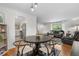 Inviting dining room flows into the living room, featuring hardwood floors and modern lighting at 2075 Oakland St, Aurora, CO 80010