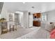 Cozy living space featuring a kitchenette, bed, stairs, and neutral tones at 2075 Oakland St, Aurora, CO 80010