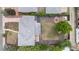 Aerial view of home showcasing a large backyard, covered patio, garden, and mature trees at 2075 Oakland St, Aurora, CO 80010
