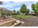 The backyard features a large lawn, a garden, a covered patio, and plenty of room for entertaining at 2075 Oakland St, Aurora, CO 80010