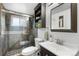 Bathroom featuring sleek fixtures, a glass-enclosed shower, and neutral colors for a relaxing ambiance at 2075 Oakland St, Aurora, CO 80010