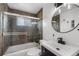 Updated bathroom features stone-look tile in the shower, with modern fixtures, and a sleek vanity at 2075 Oakland St, Aurora, CO 80010