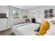 Bright bedroom featuring a window, white walls, and carpeted floor and adjoined sitting area at 2075 Oakland St, Aurora, CO 80010