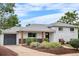 Charming brick home featuring a well-manicured front yard and attached garage at 2075 Oakland St, Aurora, CO 80010