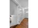 Hallway with hardwood floors and neutral walls, showcasing access to other rooms in the home at 2075 Oakland St, Aurora, CO 80010