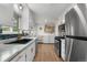 Bright, updated kitchen featuring modern appliances, new countertops, and adjacent laundry area for convenience at 2075 Oakland St, Aurora, CO 80010