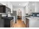 Updated kitchen with stainless steel appliances, blue backsplash and easy access to dining area at 2075 Oakland St, Aurora, CO 80010