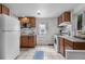 Functional kitchen with white appliances, ample cabinet space, and a bright window for natural light at 2075 Oakland St, Aurora, CO 80010