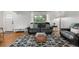 Cozy living room featuring a comfortable black leather sofa and bright window at 2075 Oakland St, Aurora, CO 80010